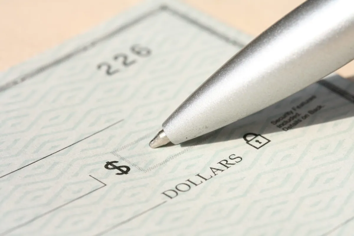 calculator next to stack of pay stubs